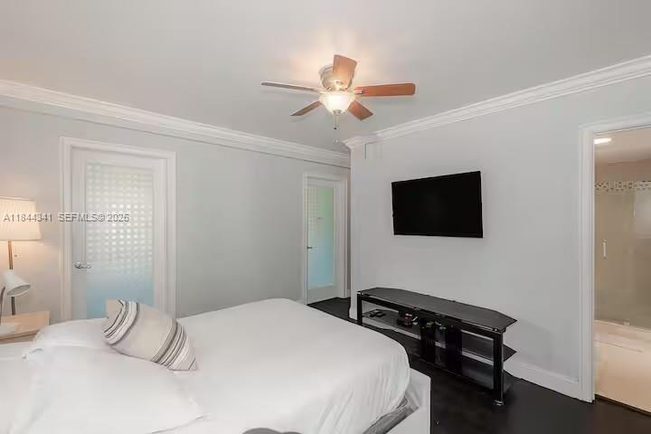 7475 Southwest 134th Street Pinecrest, FL 33156 - Photo 26 of 42 a bedroom with a bed and a flat screen tv