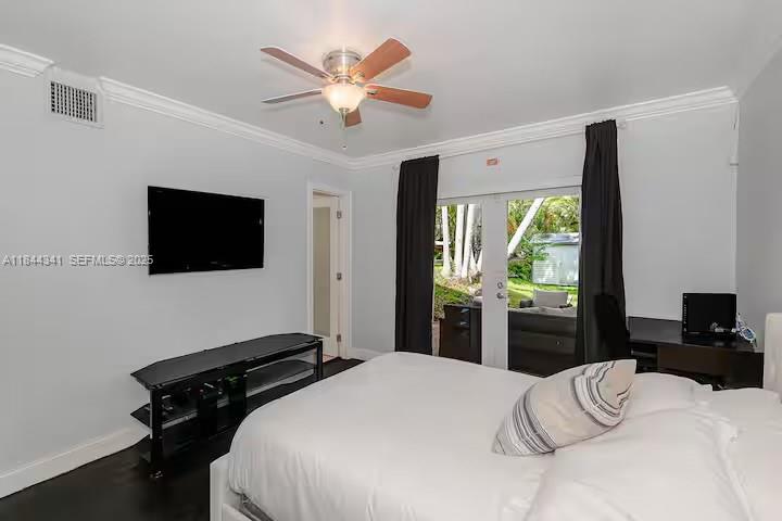 7475 Southwest 134th Street Pinecrest, FL 33156 - Photo 27 of 42 a bedroom with a bed and a flat tv screen on dresser