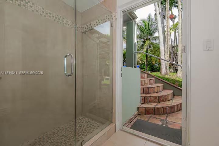7475 Southwest 134th Street Pinecrest, FL 33156 - Photo 28 of 42 a view of entryway with bathroom and glass door