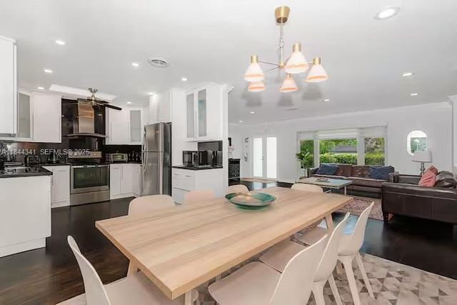 a kitchen with a table and chairs in it