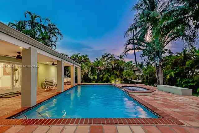 a swimming pool with outdoor seating and yard