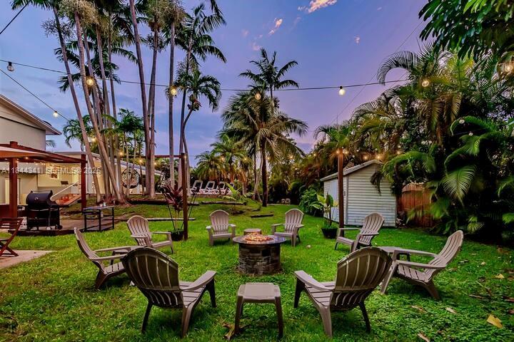 7475 Southwest 134th Street Pinecrest, FL 33156 - Photo 39 of 42 a view of a chairs and table in a yard