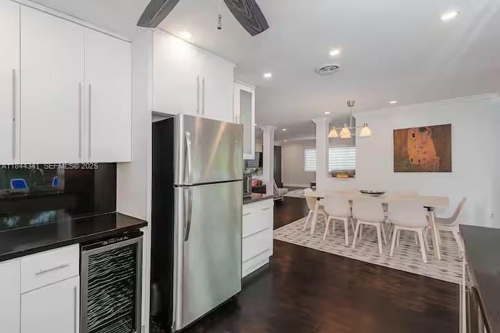 7475 Southwest 134th Street Pinecrest, FL 33156 - Photo 4 of 42 a kitchen with stainless steel appliances a refrigerator a stove a sink dishwasher with a dining table and chairs