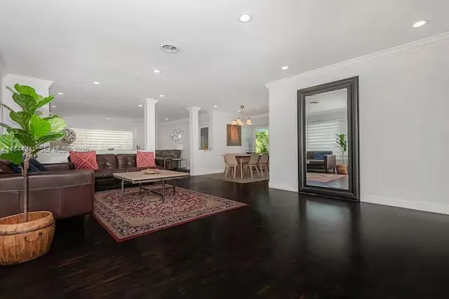 a living room with furniture and a rug