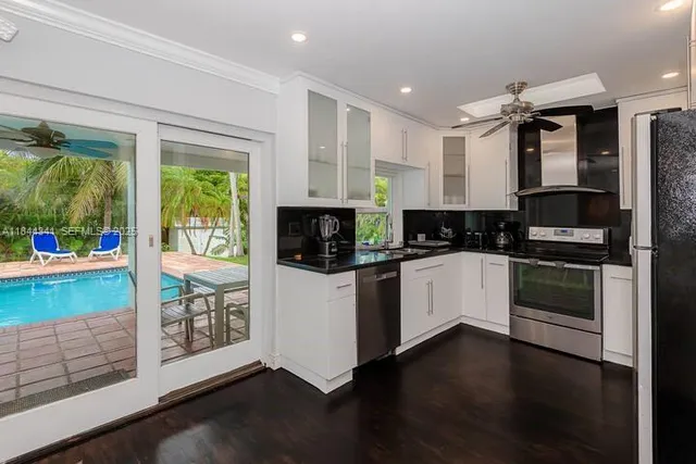 a kitchen with stainless steel appliances a stove top oven and a refrigerator