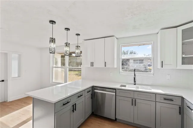 a kitchen with a sink window and cabinets