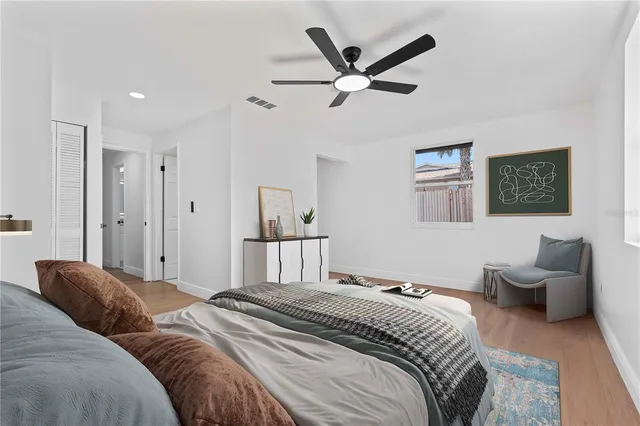 a bedroom with a large bed and a chandelier
