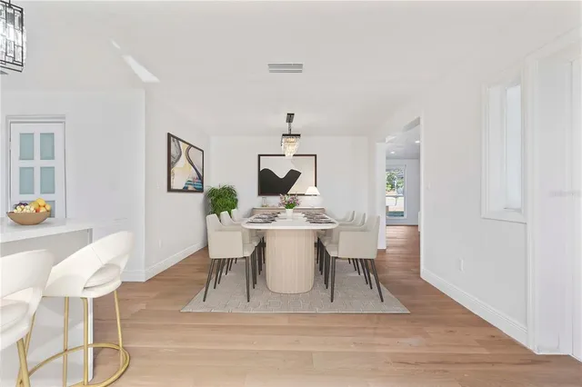 a view of a dining room with a table and chairs