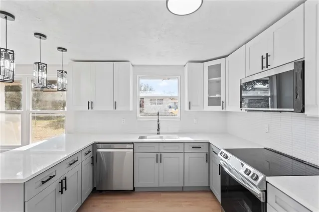 a kitchen with a sink stove and cabinets