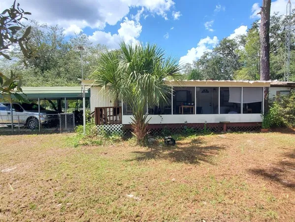 a view of a house with a yard patio and swimming pool