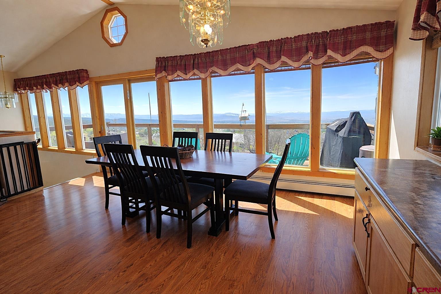21976 2225th Road Cedaredge, CO 81413 - Photo 8 of 36 a dining room with furniture a chandelier and wooden floor