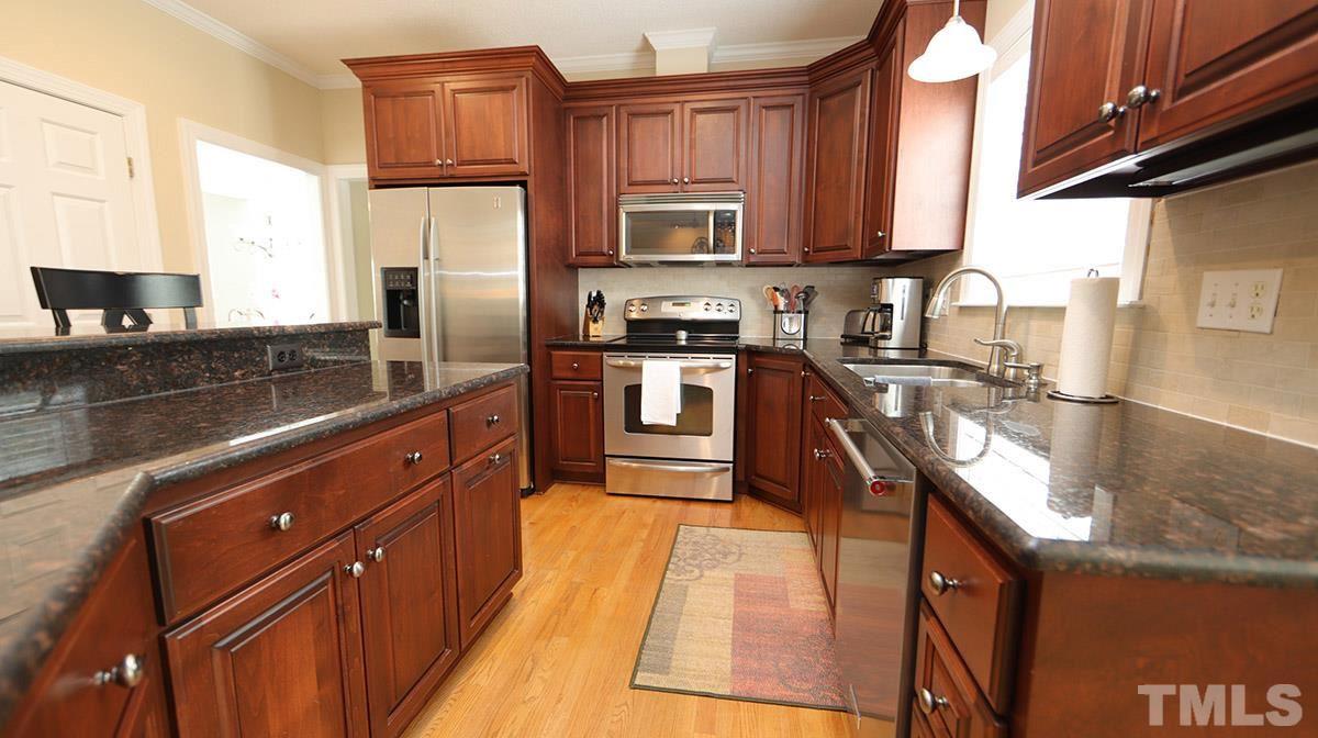 3820 Evander Way Raleigh, NC 27613 - Photo 11 of 30 A view of the cabinets and island on the work side of the kitchen. There is an abundance of storage in the cabinets as well as in the double door pantry.