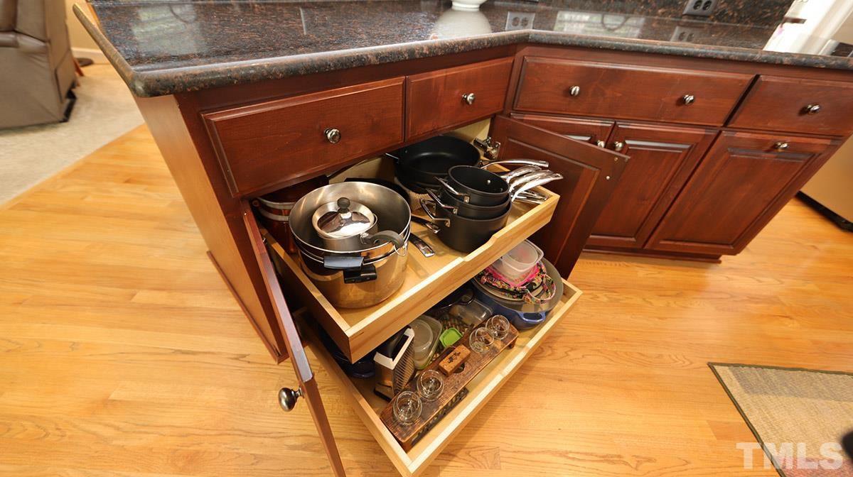 3820 Evander Way Raleigh, NC 27613 - Photo 12 of 30 Some of the cabinets have rollouts for convenience.