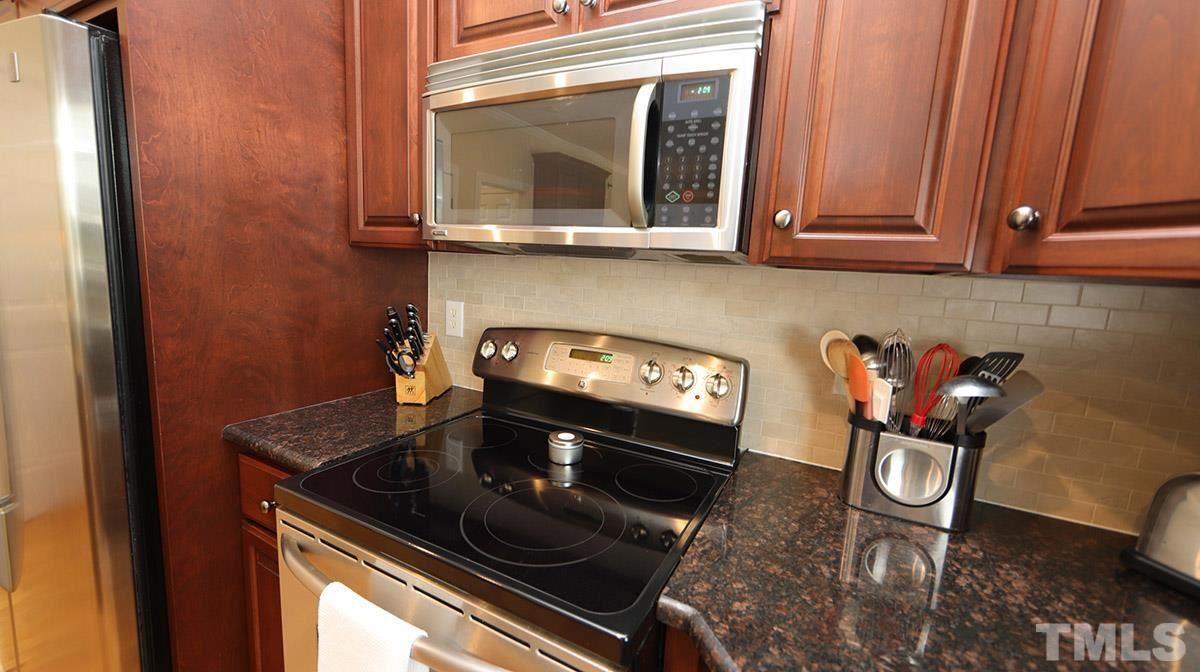 3820 Evander Way Raleigh, NC 27613 - Photo 13 of 30 A closer view of the appliances and tile backsplash.