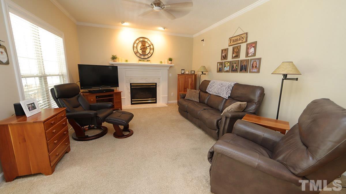 3820 Evander Way Raleigh, NC 27613 - Photo 15 of 30 The family room is open to the kitchen and is really cozy. There is a gas log fireplace with impressive mantel and surround. The room is wired for speakers as well.