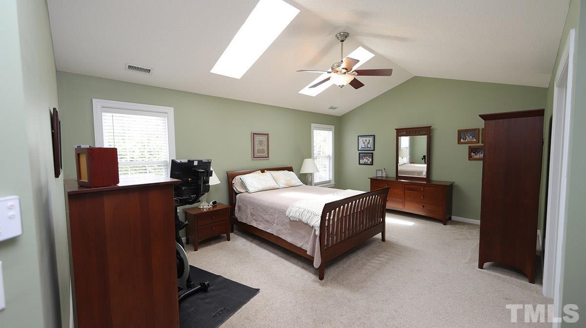 3820 Evander Way Raleigh, NC 27613 - Photo 17 of 30 The master bedroom is huge! The vaulted ceiling makes it live even larger. There are 2 skylights and a great fan! The "This girl is on fire" rack does not convey.