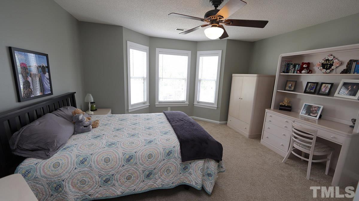 3820 Evander Way Raleigh, NC 27613 - Photo 26 of 30 This is the largest bedroom. It also has a bay window & fan. There is access to the attic via pull down stairs.