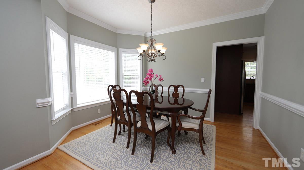 3820 Evander Way Raleigh, NC 27613 - Photo 7 of 30 Chair rail and crown molding accent the dining room.