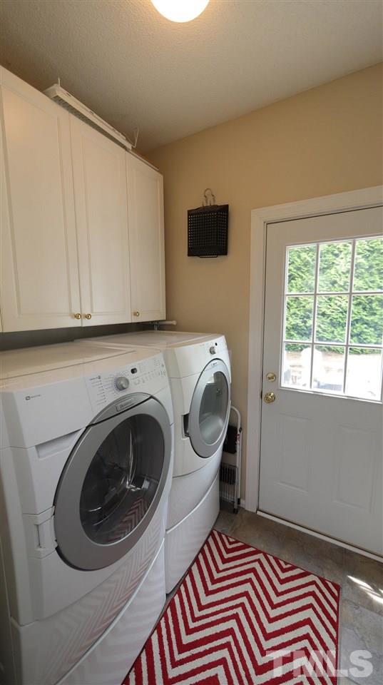 3820 Evander Way Raleigh, NC 27613 - Photo 9 of 30 The laundry room is conveniently tucked away down the hall behind the kitchen and there is a door with access to the patio. There are cabinets for storage.