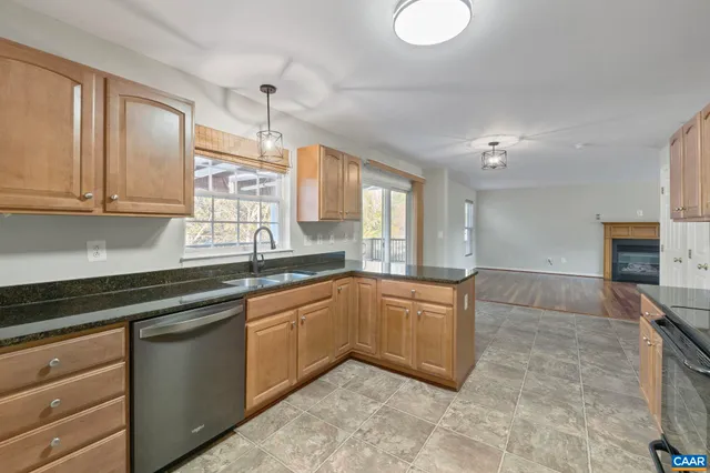 a kitchen with granite countertop a sink cabinets and window