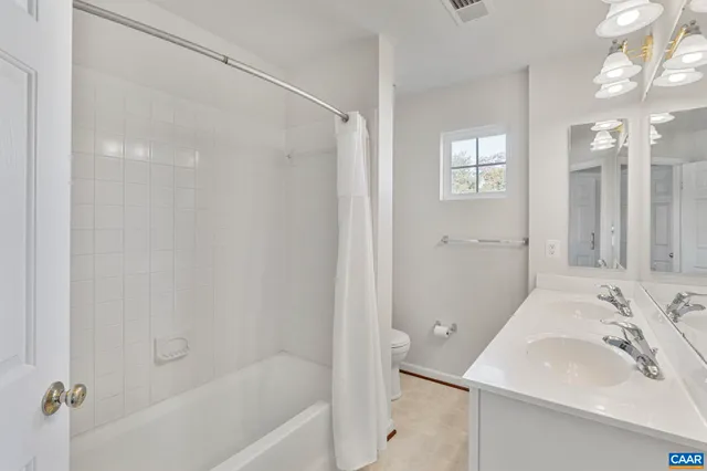 a white bath tub sitting next to a white sink