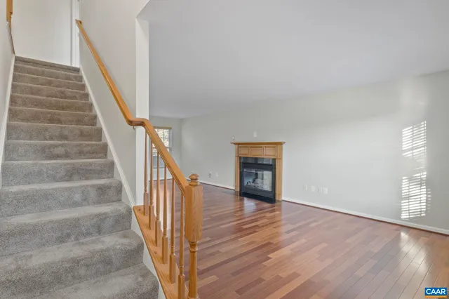 a view of staircase with white walls and wooden floor