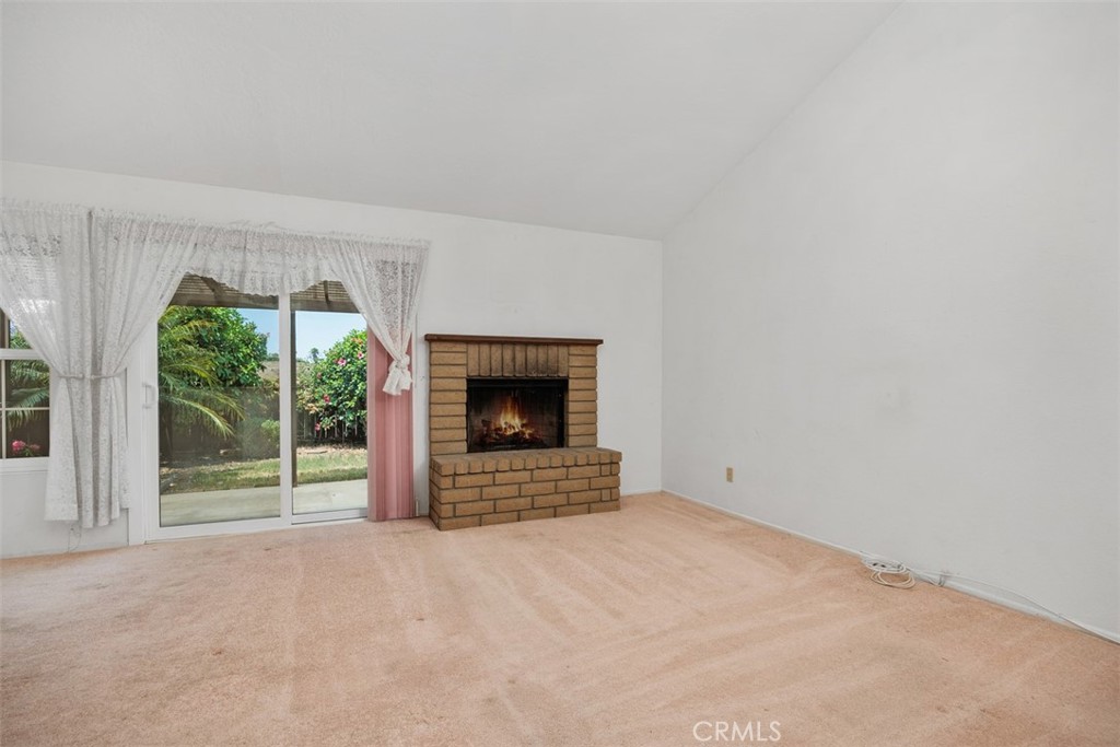 1744 Woodlark Lane Fallbrook, CA 92028 - Photo 12 of 38 a view of an empty room with a fireplace and a window