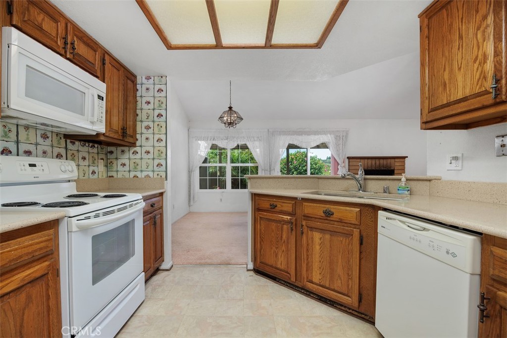 1744 Woodlark Lane Fallbrook, CA 92028 - Photo 17 of 38 a kitchen with stainless steel appliances granite countertop a stove a sink and a microwave