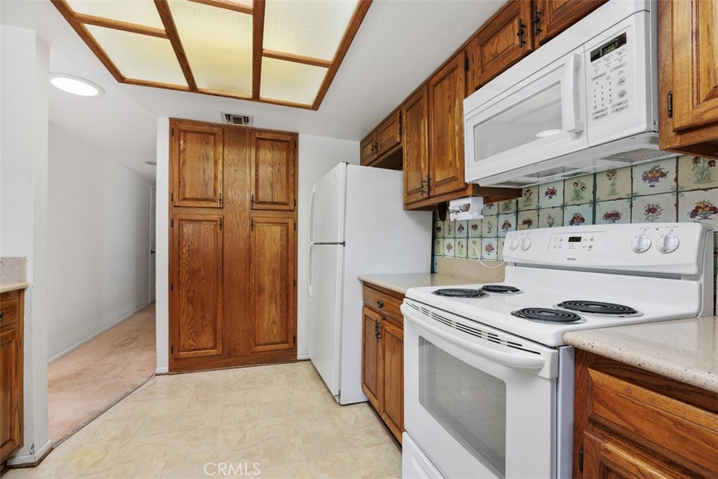 1744 Woodlark Lane Fallbrook, CA 92028 - Photo 18 of 38 a kitchen with stainless steel appliances granite countertop a stove and a refrigerator