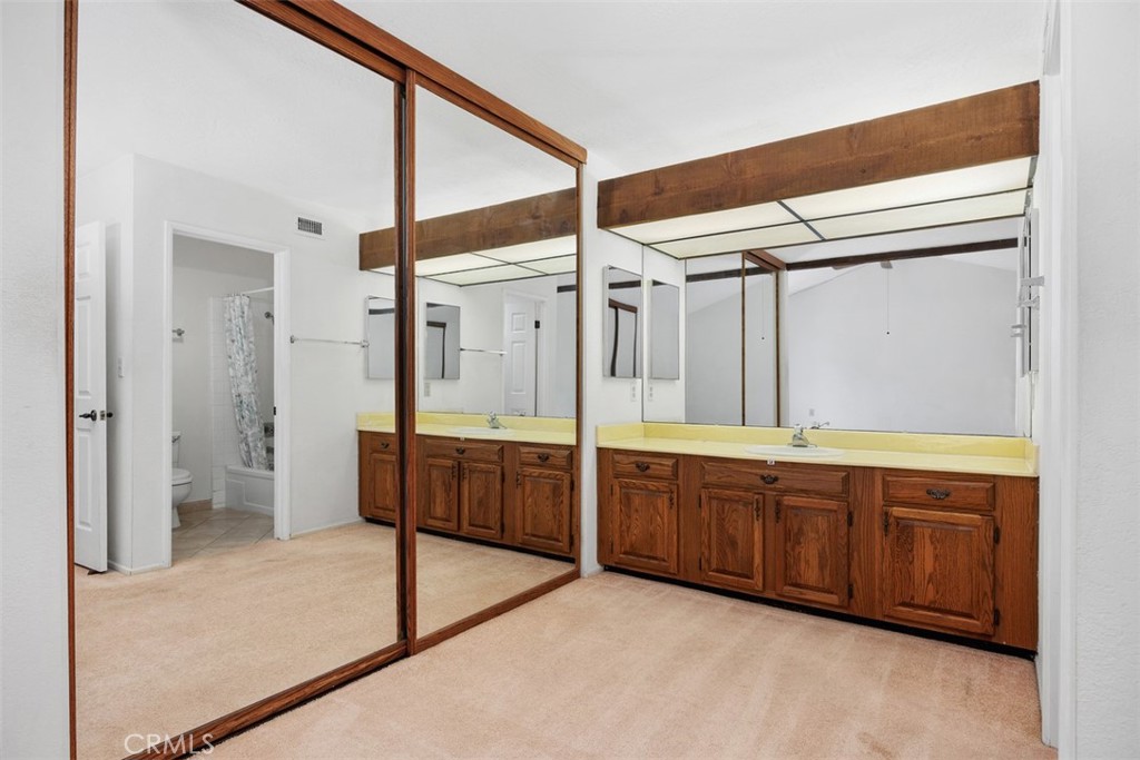 1744 Woodlark Lane Fallbrook, CA 92028 - Photo 23 of 38 a large bathroom with a tub mirror and sink