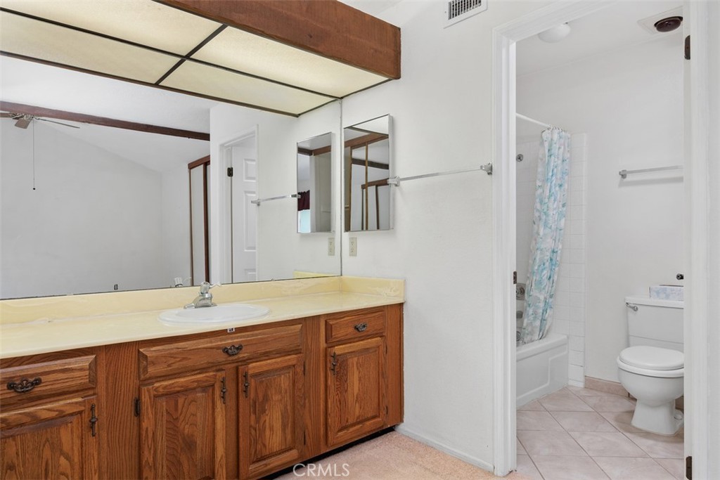 1744 Woodlark Lane Fallbrook, CA 92028 - Photo 24 of 38 a spacious bathroom with a granite countertop sink a toilet and shower