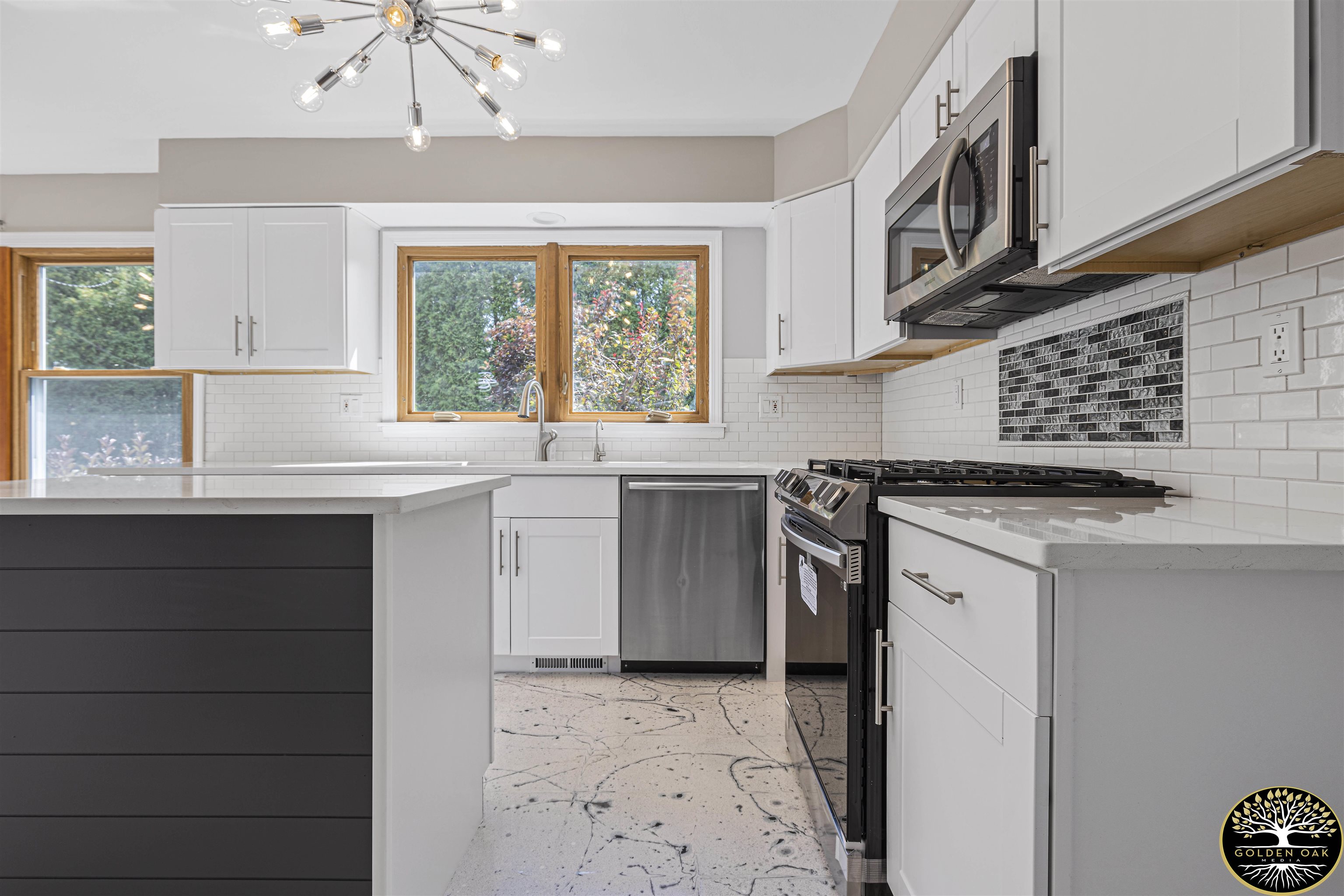 4951 Welsh Road Rockford, IL 61107 - Photo 11 of 45 a kitchen with stainless steel appliances granite countertop a sink a stove and a refrigerator