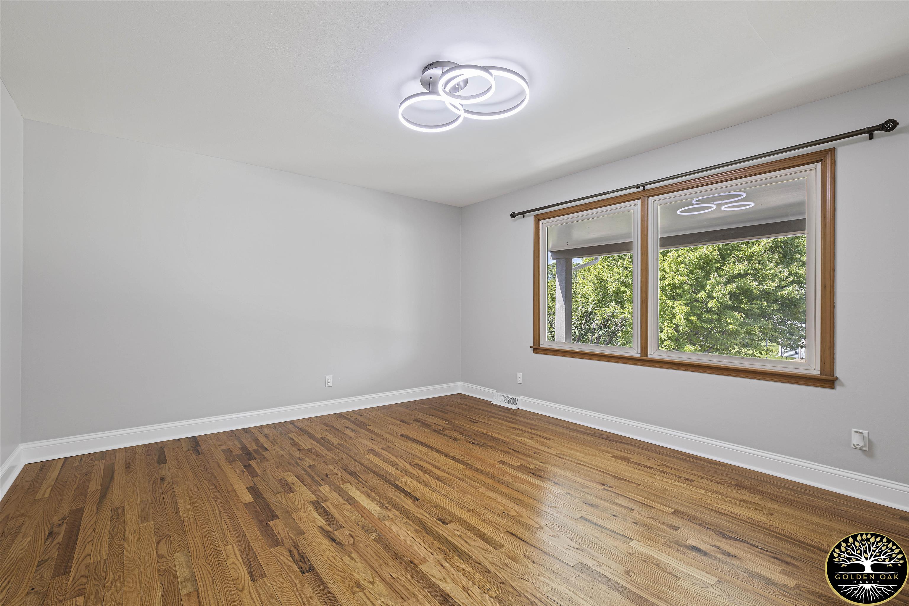 4951 Welsh Road Rockford, IL 61107 - Photo 19 of 45 wooden floor in an empty room with a window