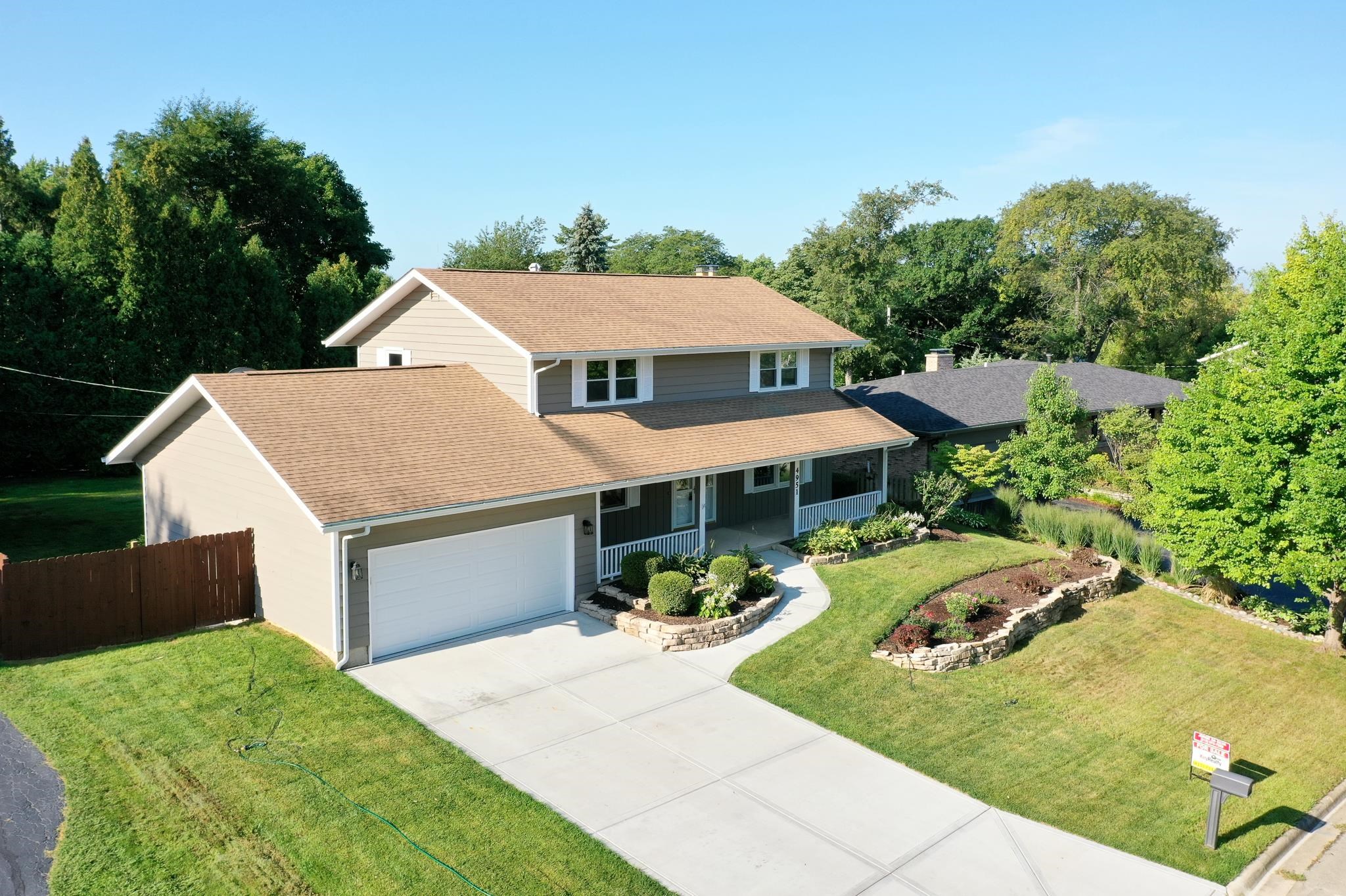 4951 Welsh Road Rockford, IL 61107 - Photo 4 of 45 a aerial view of a house with table and chairs under an umbrella