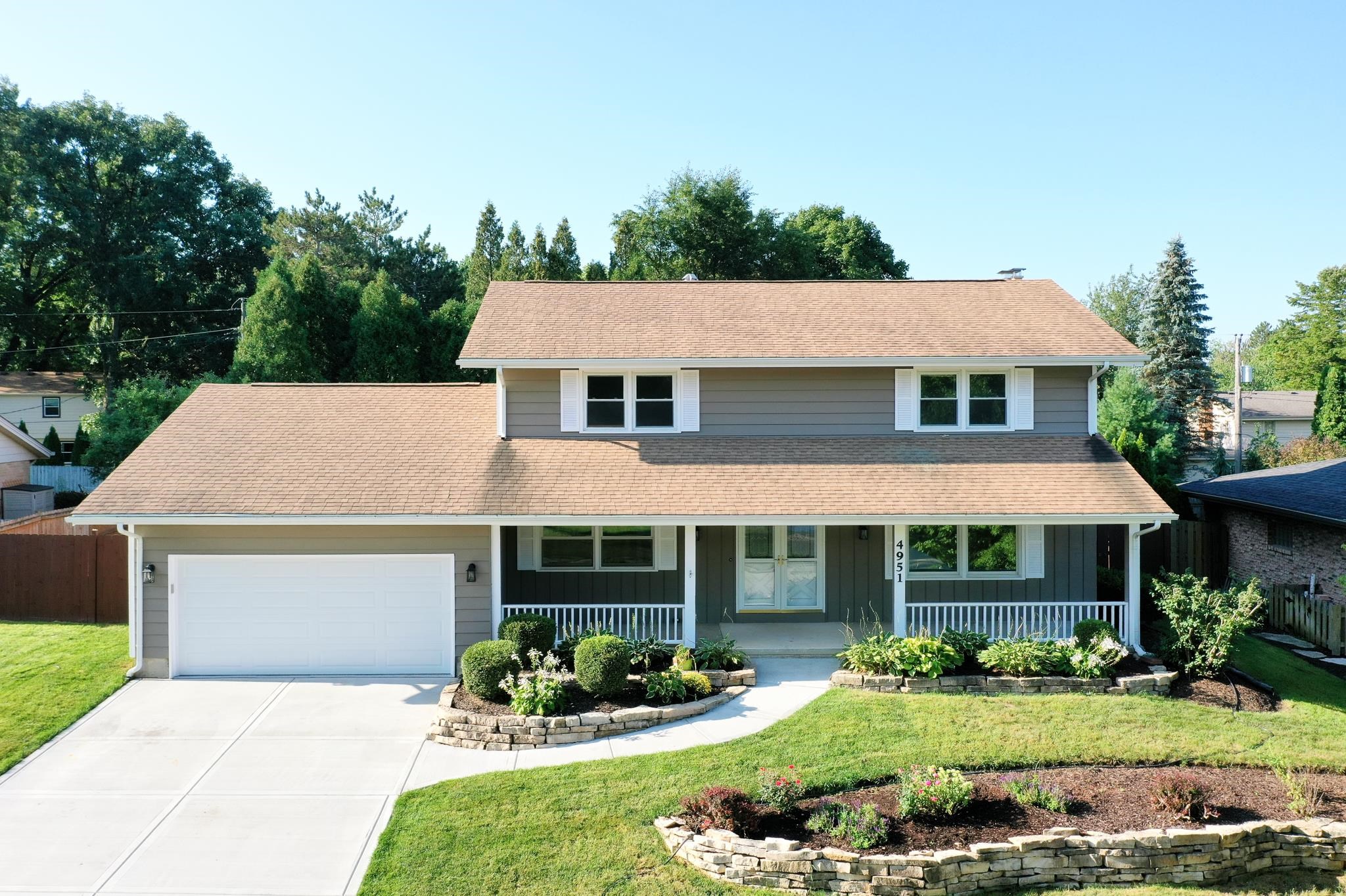4951 Welsh Road Rockford, IL 61107 - Photo 5 of 45 a front view of a house with a yard table and chairs