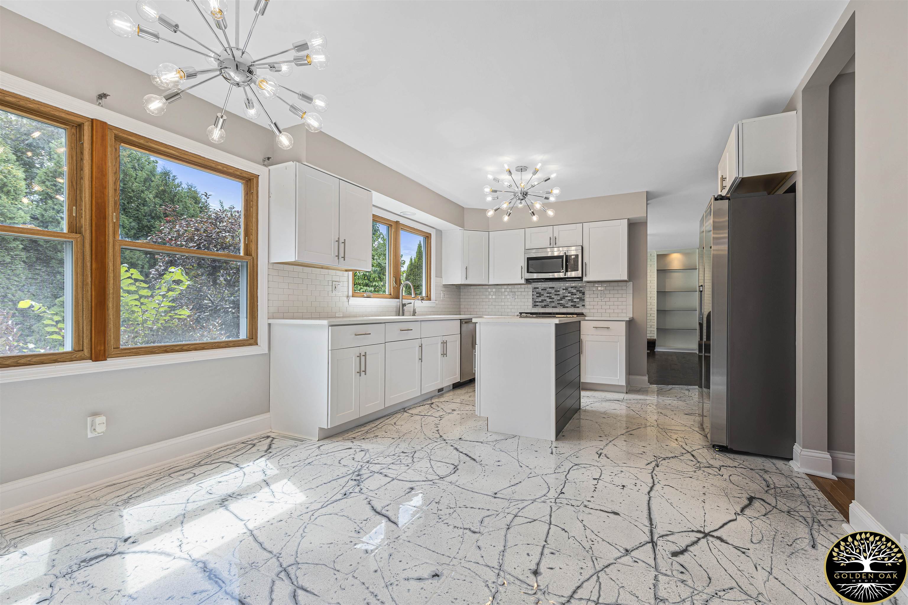 4951 Welsh Road Rockford, IL 61107 - Photo 9 of 45 a kitchen with stainless steel appliances kitchen island granite countertop a refrigerator oven a sink and dishwasher with a large window