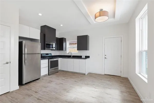a kitchen with a refrigerator and a sink