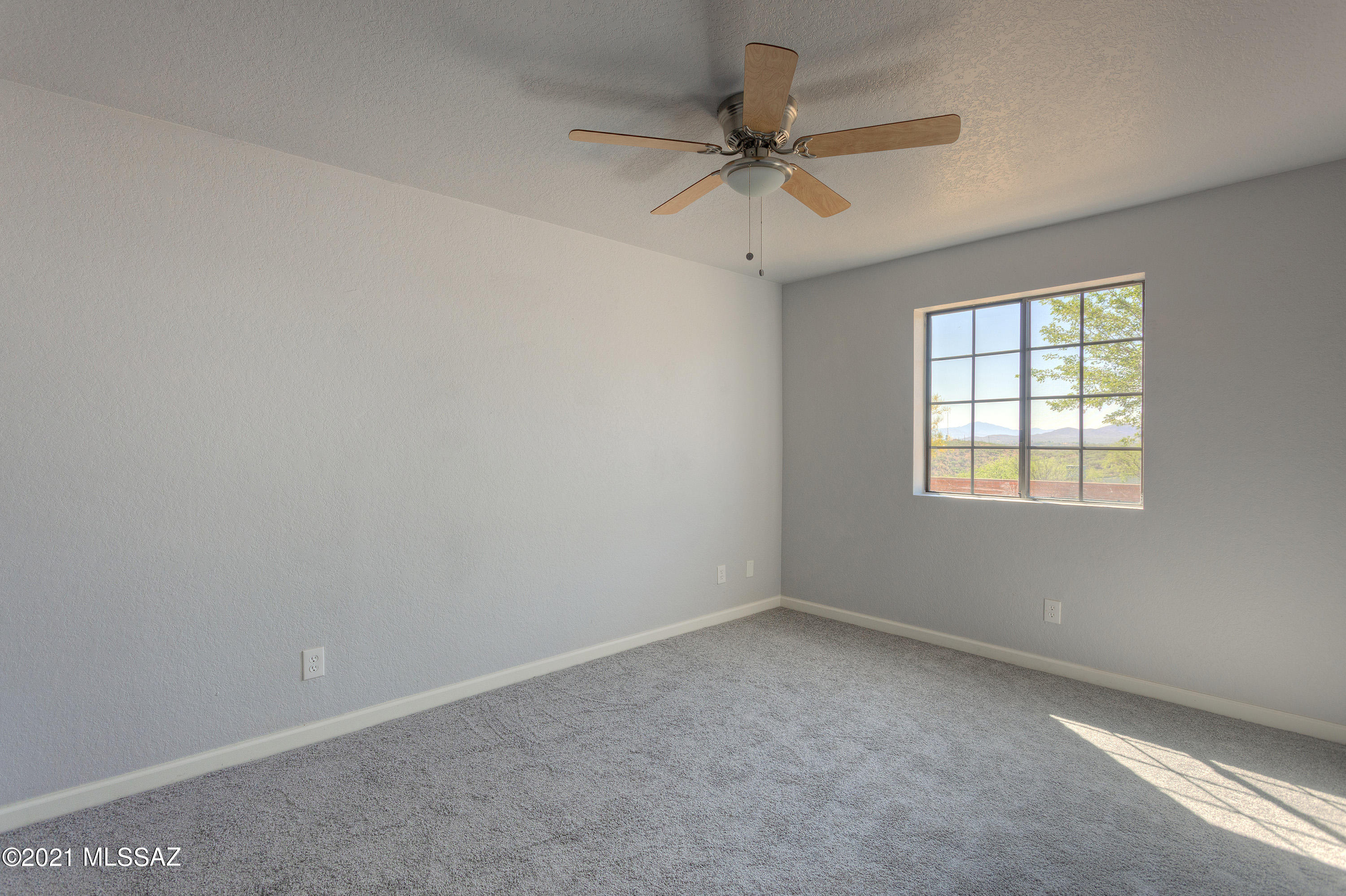1096 Montosa Circulo Rio Rico, AZ 85648 - Photo 22 of 39 an empty room with a window and a fan
