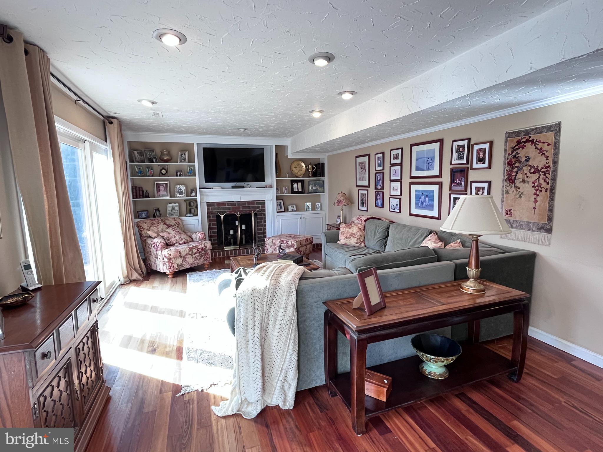145 Joanne Road Holland, PA 18966 - Photo 11 of 54 a living room with furniture a flat screen tv and a fireplace