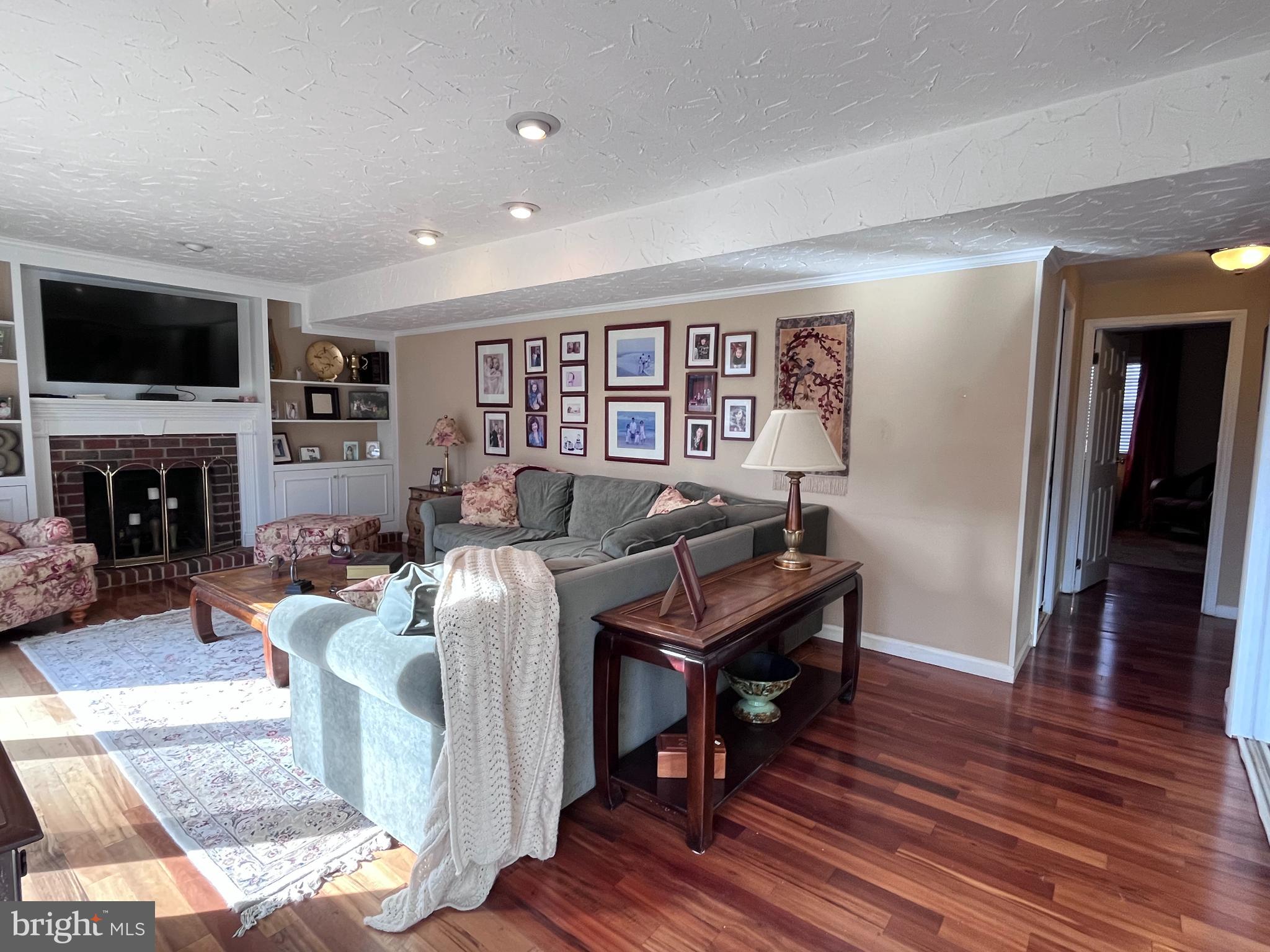 145 Joanne Road Holland, PA 18966 - Photo 12 of 54 a living room with furniture a flat screen tv and a fireplace