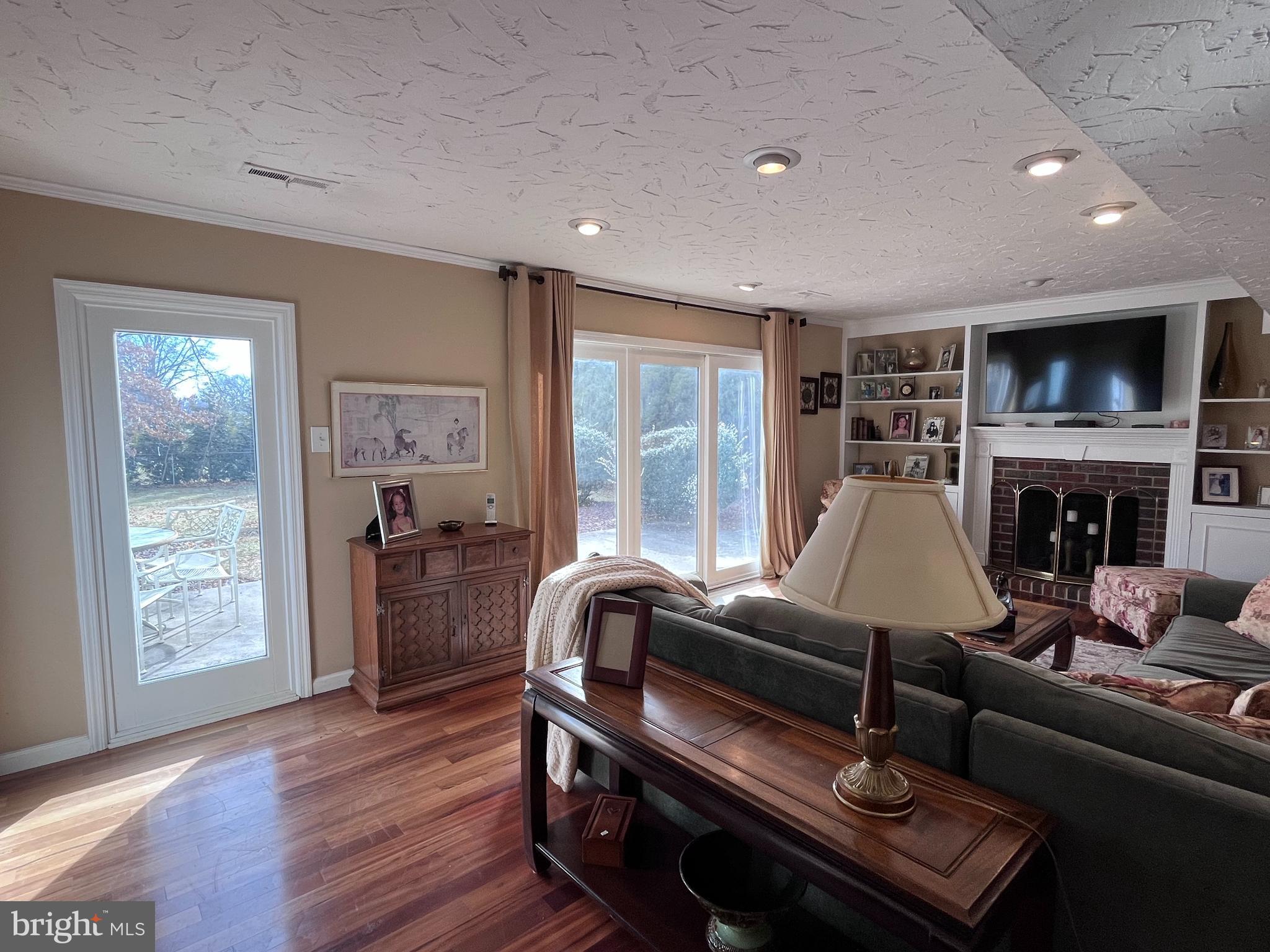 145 Joanne Road Holland, PA 18966 - Photo 13 of 54 a living room with furniture a flat screen tv and a fireplace