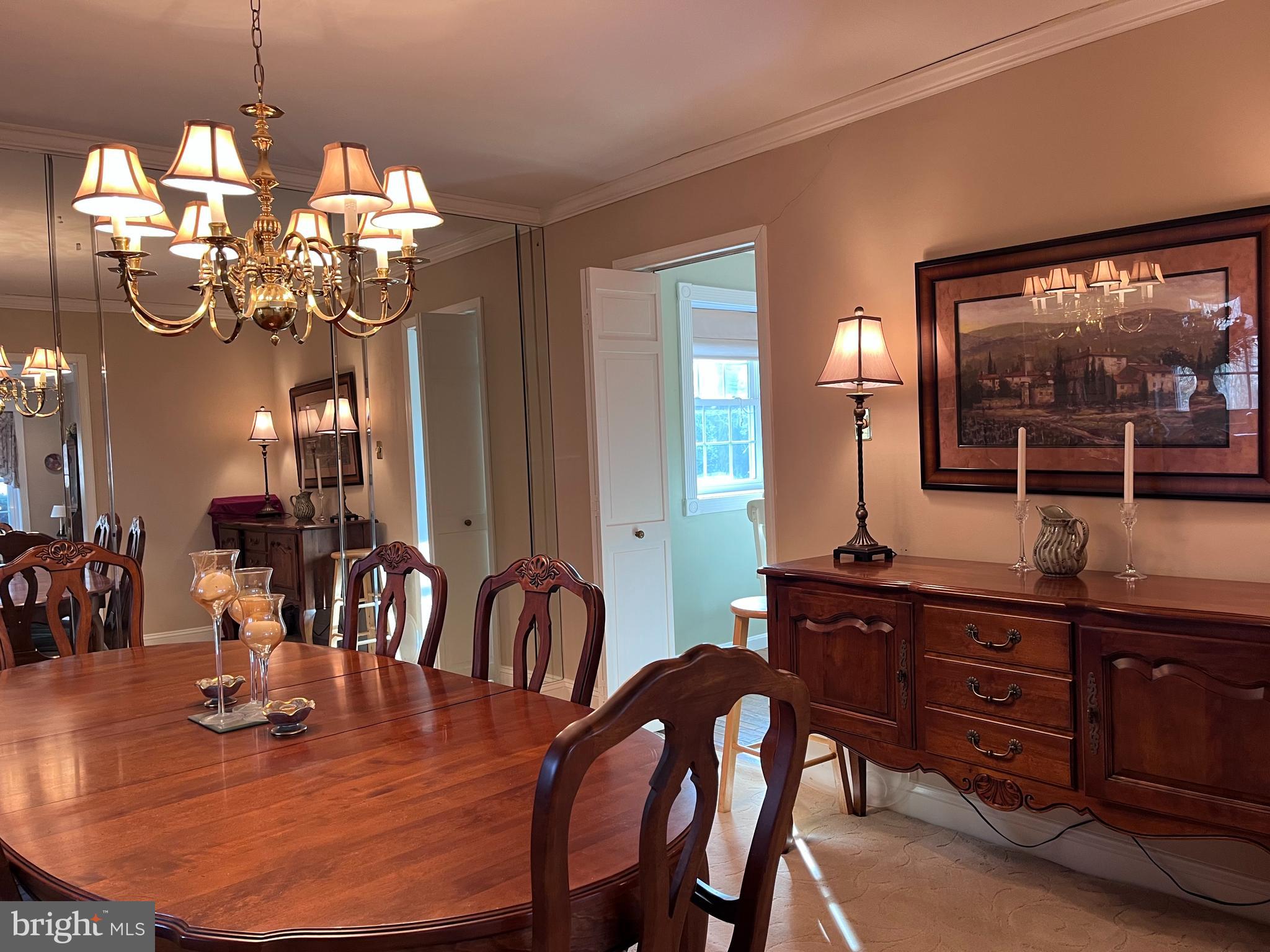 145 Joanne Road Holland, PA 18966 - Photo 30 of 54 a dining room with wooden floor a chandelier a wooden table and chairs