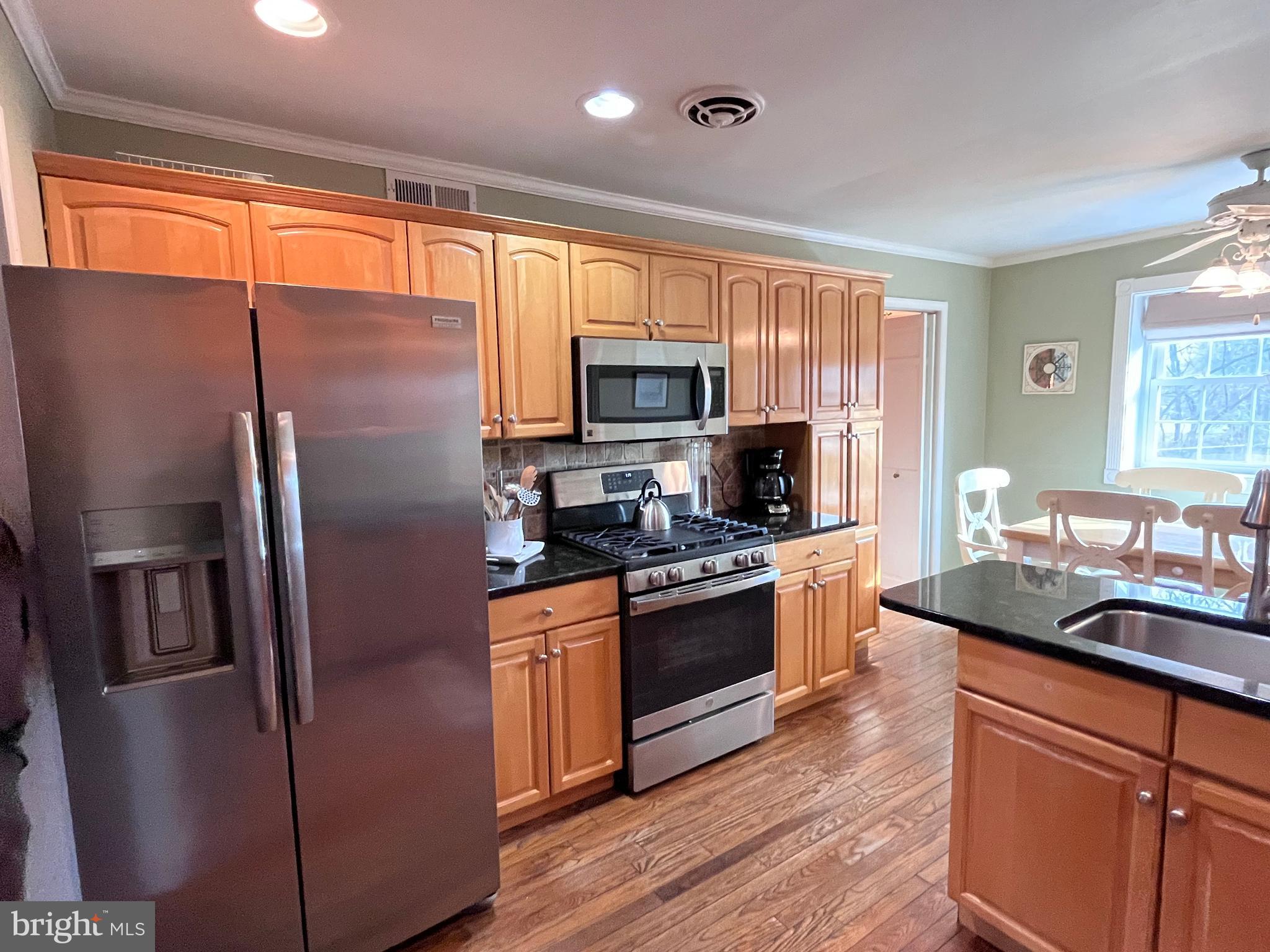 145 Joanne Road Holland, PA 18966 - Photo 3 of 54 a kitchen with stainless steel appliances granite countertop a refrigerator a stove top oven a sink and dishwasher