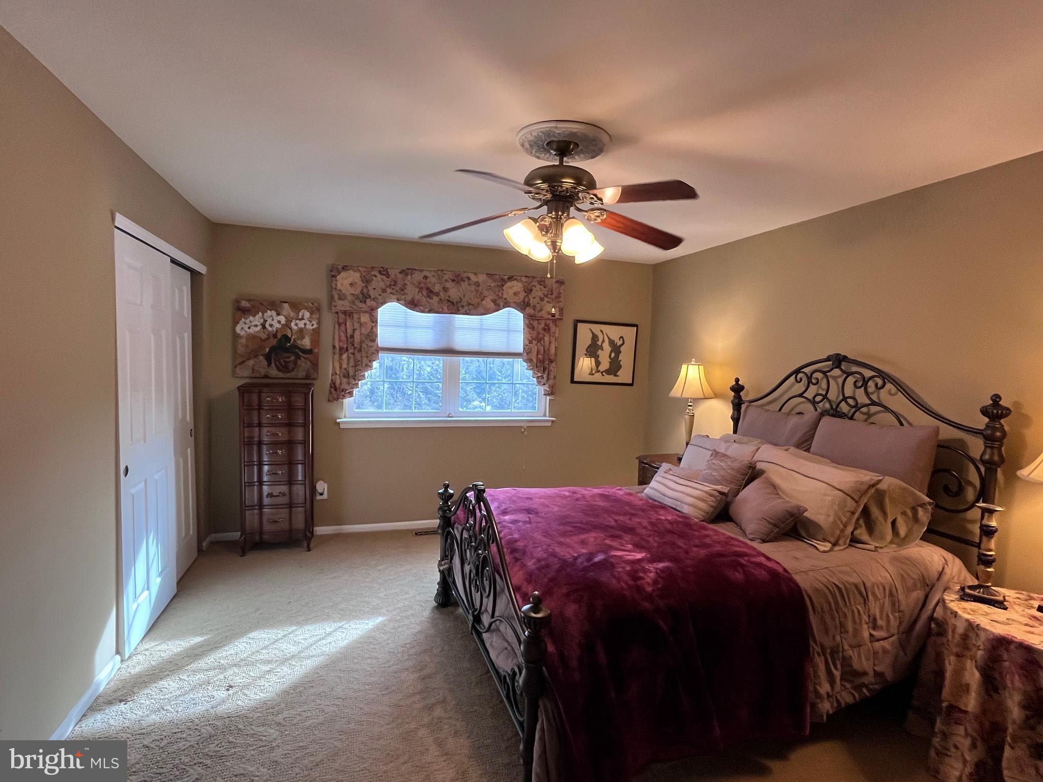 145 Joanne Road Holland, PA 18966 - Photo 34 of 54 a bedroom with a bed and a chandelier