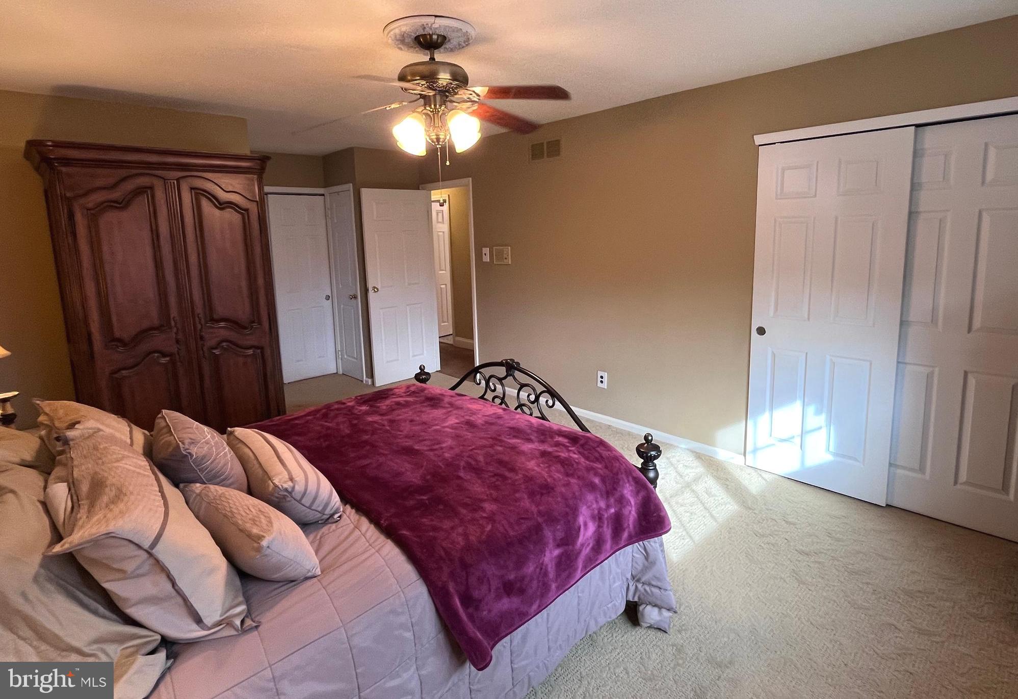 145 Joanne Road Holland, PA 18966 - Photo 36 of 54 a bedroom with a bed and a chandelier