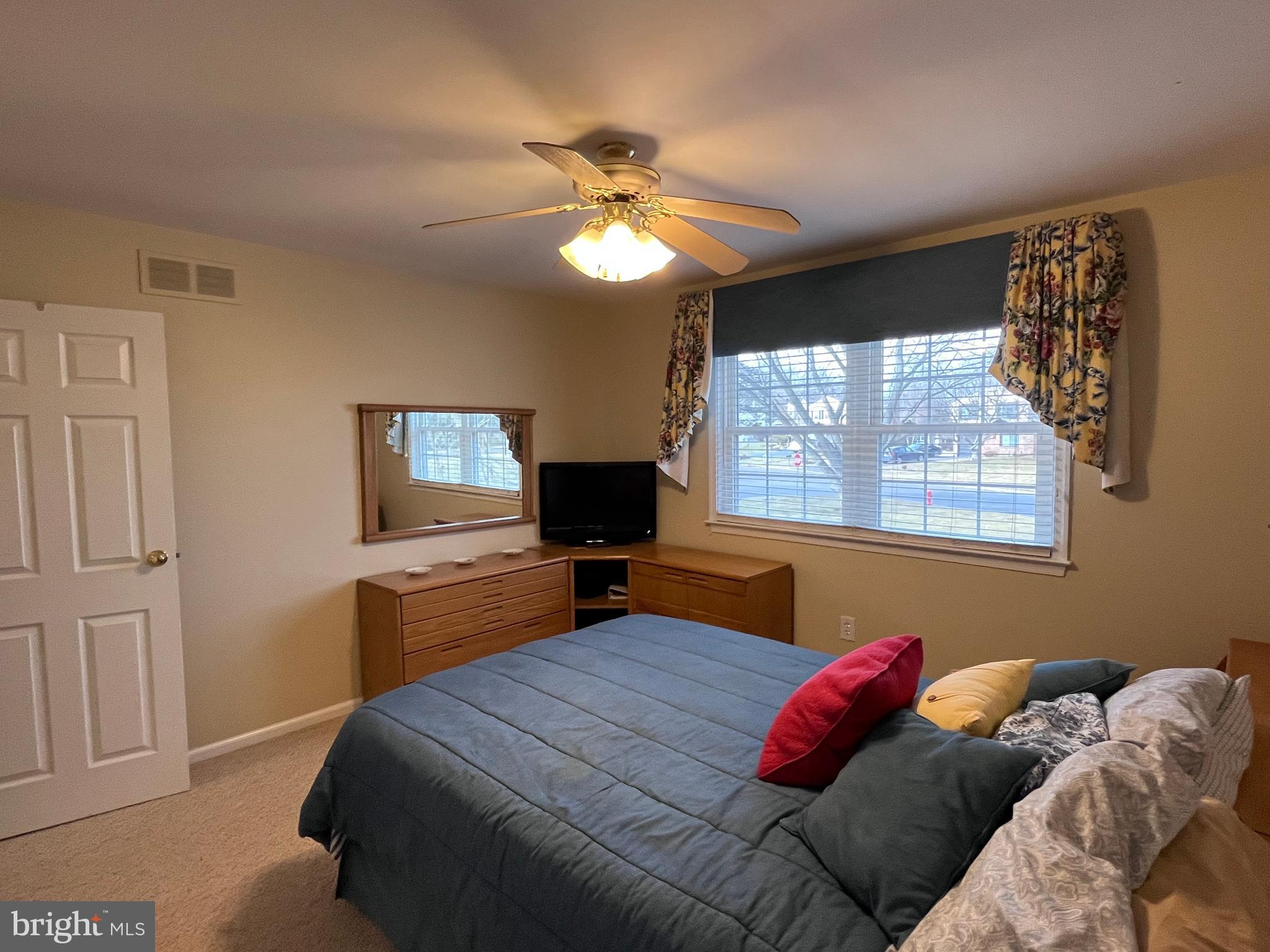 145 Joanne Road Holland, PA 18966 - Photo 44 of 54 a bedroom with a bed and a chandelier