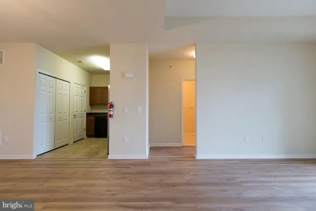 a view of a kitchen with a sink and a refrigerator
