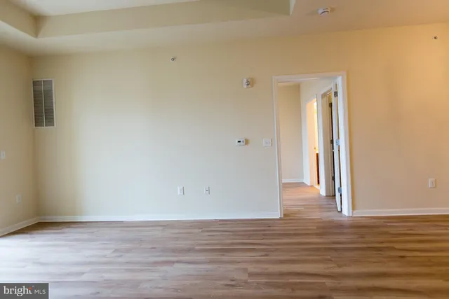 a view of a room with wooden floor