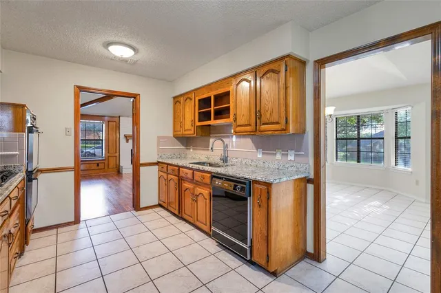 a kitchen with stainless steel appliances granite countertop a stove and a sink
