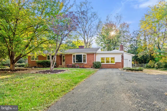 a front view of a house with plants